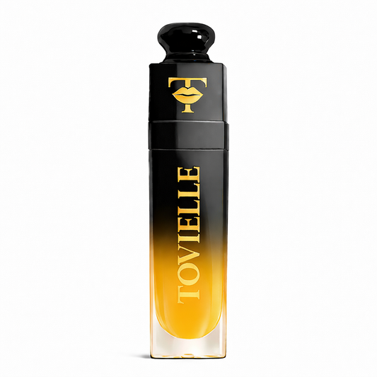 TOVIELLE Mango Glow Lip Oil in warm tropical shade with glossy finish in clear tube with gold cap on neutral background