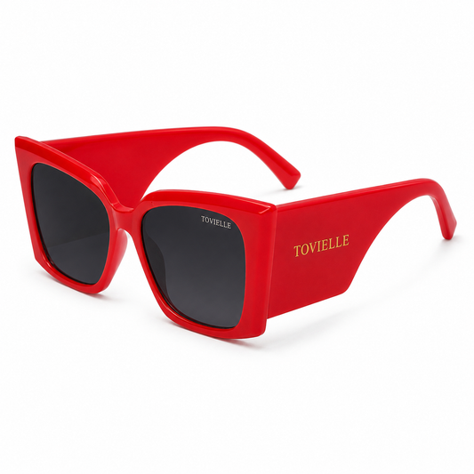 Tovielle Riviera Rouge luxury sunglasses featuring an oversized red frame, dark tinted lenses, and signature gold logo detailing on a clean studio background.
