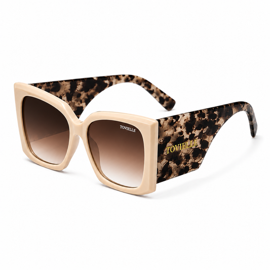 Tovielle Riviera Tortoise luxury sunglasses featuring an oversized ivory frame, tortoise pattern temples, gradient tinted lenses, and signature gold logo detailing on a clean studio background.