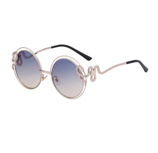 Sunglasses with decorative frame and gradient lenses on a white background