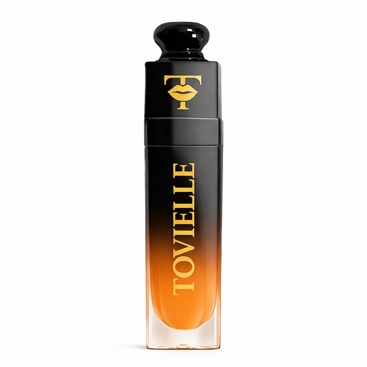 TOVIELLE Passion Fruit Glow Lip Oil in warm tropical shade with glossy finish in clear tube with gold cap on neutral background