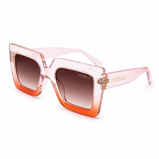 Oversized translucent blush Regent Rose sunglasses by Tovielle with coral gradient frame, soft tinted lenses and gold accents